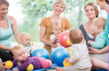 group of mothers sitting in a circle playing with their babies, looking not realistically stressed.